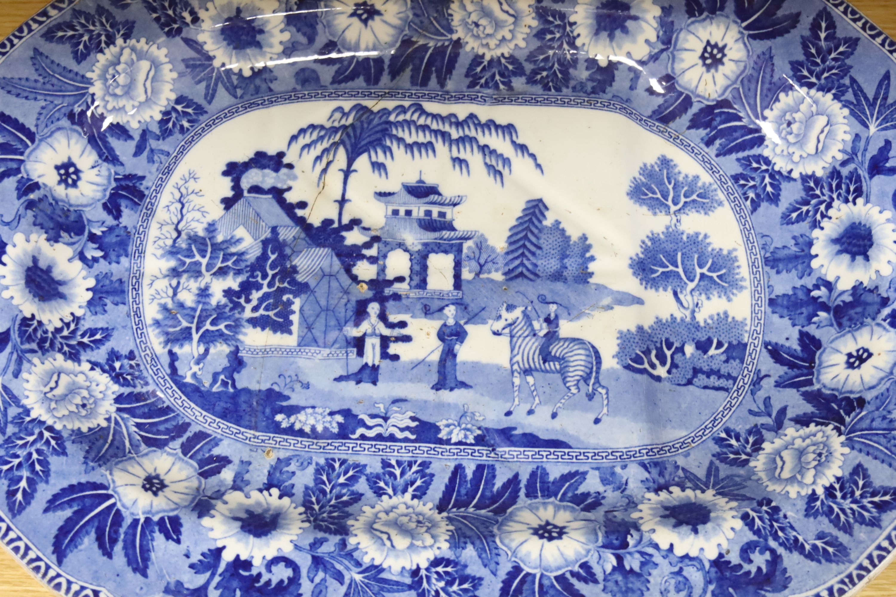 A late 19th century blue and white pottery meat dish, width 50cm, two plates and a Chinese style dish